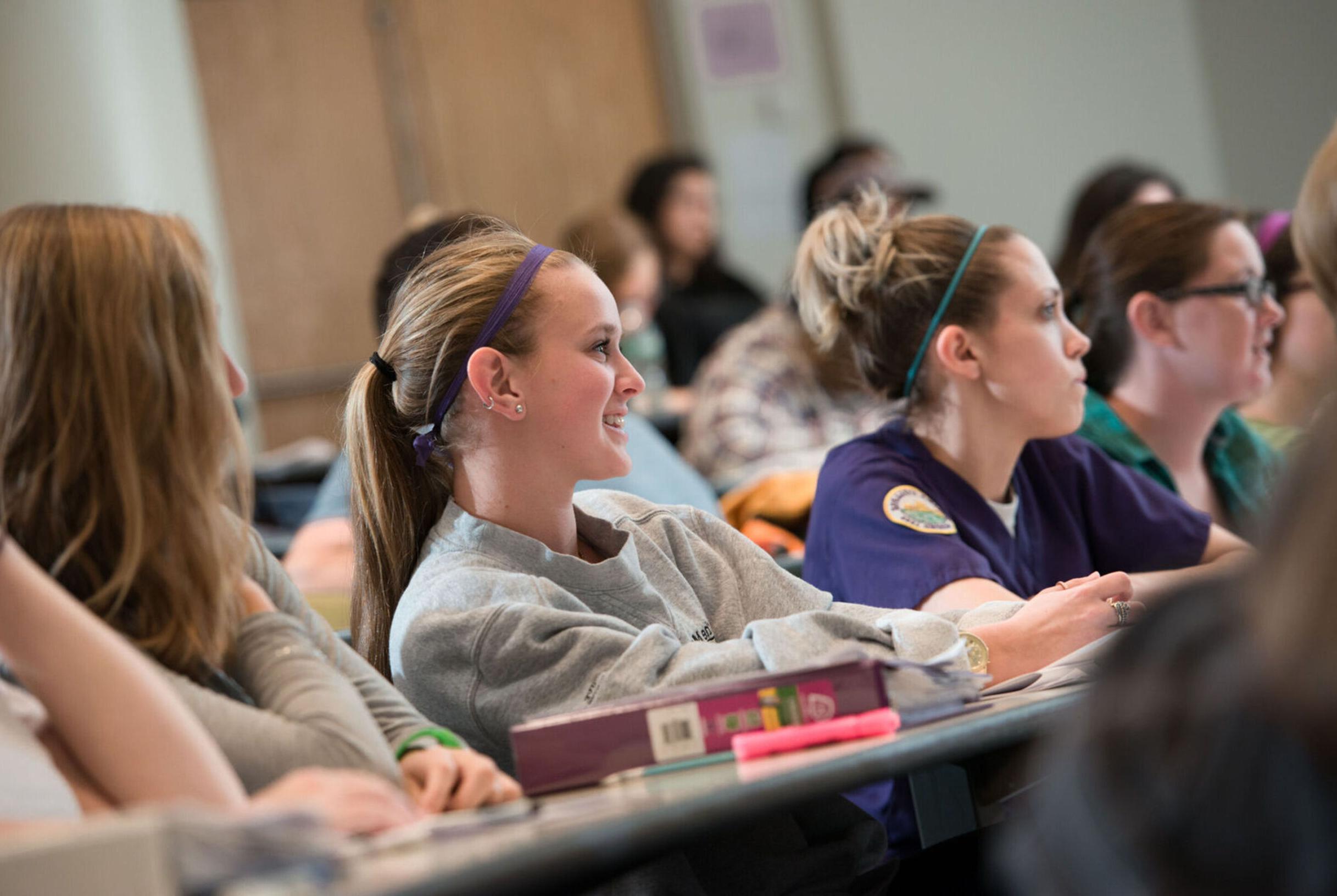 Students listen to the teacher in a lecture hall