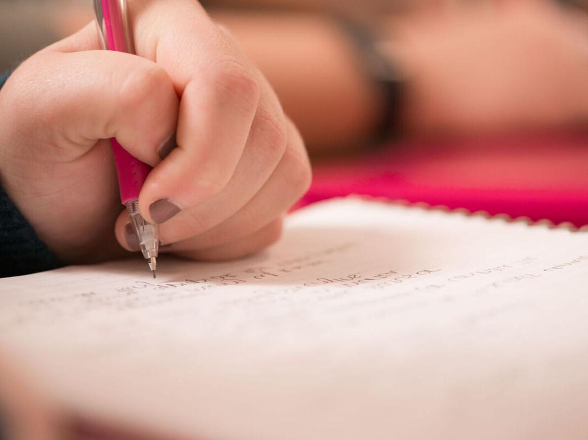 A student takes notes in a class